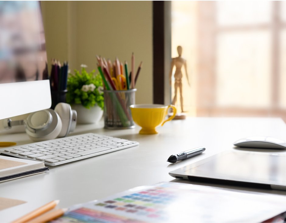 desk with computer and tablet and pencils