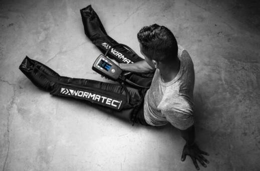 Photograph of a person wearing NormaTec recovery boots
